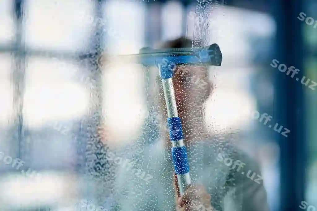 Toza gigiena rasmi yosh erkak ofisdagi oynalarni tozalash | Clean hygienic shot young man cleaning windows office